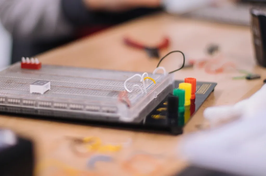 Breadboard prototype and hand tools on an engineering workbench